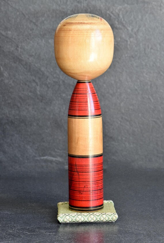Agatsuma Kichisuke kokeshi full body view from the back showing plain unpainted wooden head and back