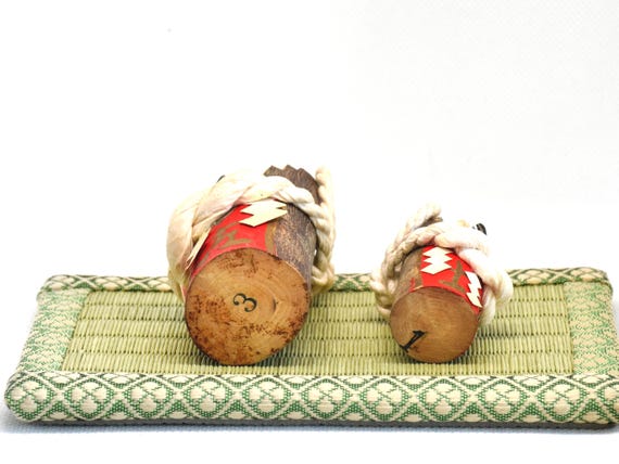 Japanese Inuhariko Guardian Dog Figurines kokeshi dolls, base showing numbered markings and natural wood grain