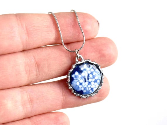 Kiyomizu-yaki Blue Floral Pendant Necklace shown next to a hand for scale and size