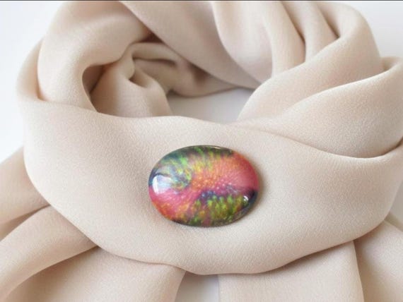 Kutani ceramic brooch displayed on a light beige scarf