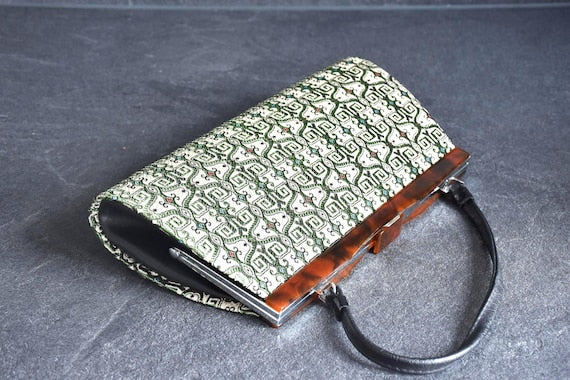 Kotan-Ori Kimono Bag viewed from the side with the structured clasp and leather handle
