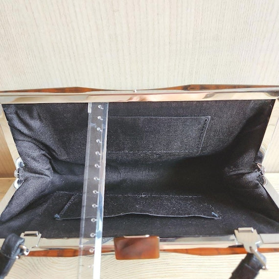 Kotan-Ori Kimono Bag interior view showing the black fabric lining and small inner pocket with a ruler