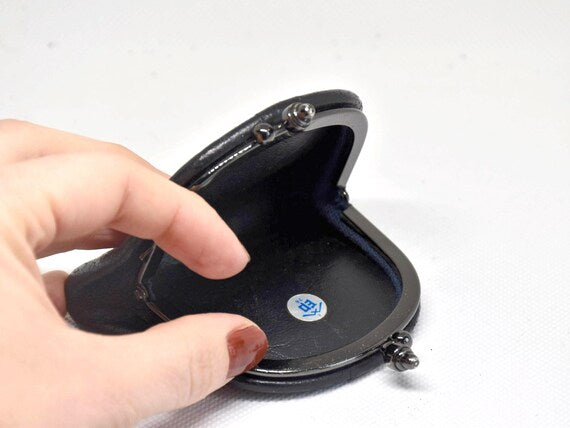 Japanese Deerskin Inden Coin Purse shown open with hand holding the interior and blue lining visible