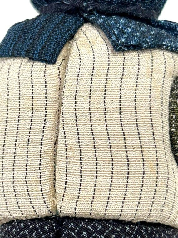 Omeshi Ningyō Doll traditional Japanese kokeshi doll close-up of striped Omeshi silk textile pattern