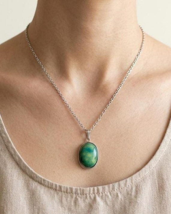 Green Oval Kutani Pendant Necklace worn on a person with a silver-tone chain