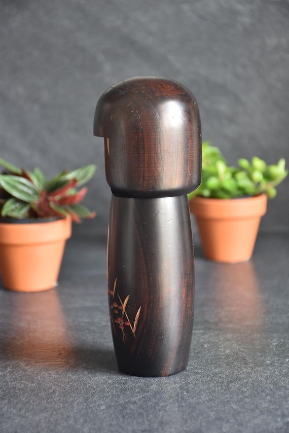 Usaburo Creative Kokeshi Doll back view showing the dark polished wooden hair and sleek form
