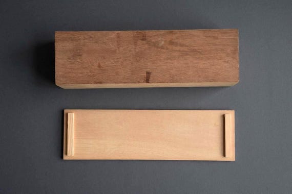 Japanese Kiribako Calligraphy Box showing the underside of the wooden storage box and the back of the sliding lid