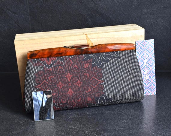 Oshima Tsumugi Kimono Bag frontal perspective featuring patterned silk textile and accompanying mirror