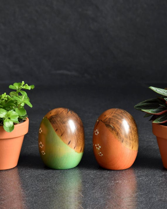 Usaburo Creative Kokeshi Pair shown from the side, highlighting wood grain and rounded shapes