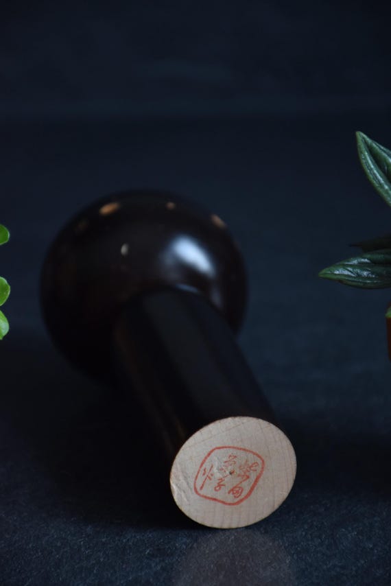 Japanese Kokeshi Doll base with signature stamp on the bottom of the wooden piece