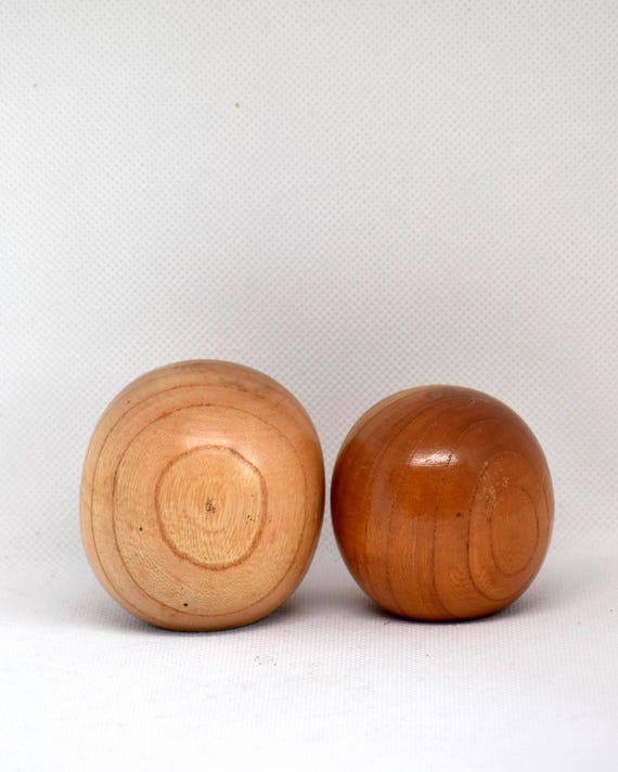 Creative Kokeshi Pair vintage wooden Japanese dolls showing the circular base and bottom wood grain