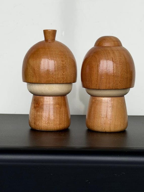 Masashi Takeda kokeshi dolls back view highlighting the natural wood grain