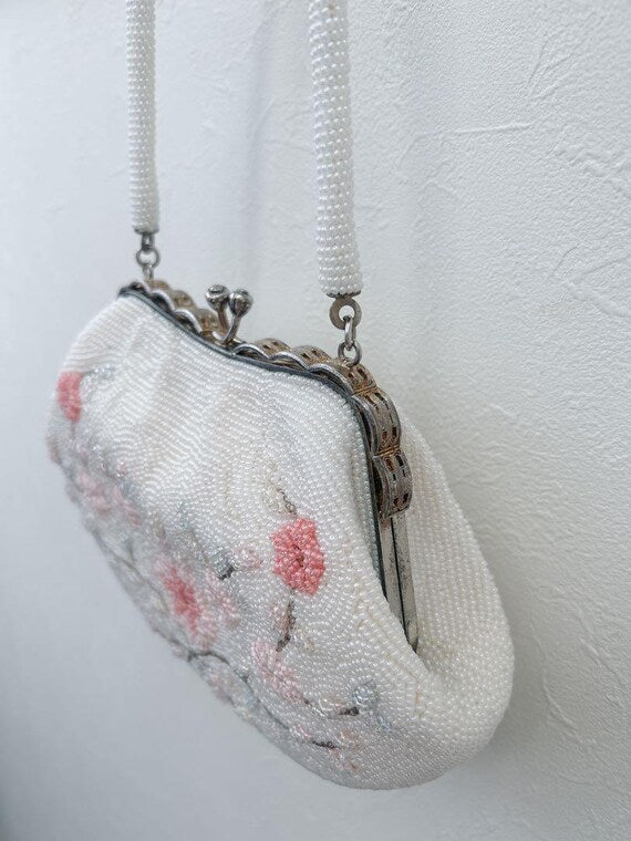 Japanese Floral Beaded Clutch Bag angled view against a neutral wall showing the beaded handle