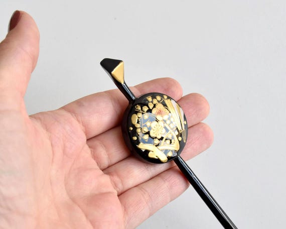 Kogai Hairpin Wood Lacquer Floral shown held in a hand for size perspective