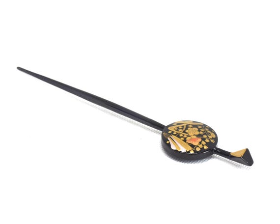 Kogai Hairpin Wood Lacquer Floral viewed at an angle on a white surface