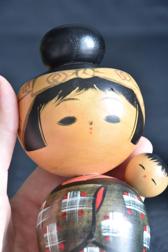 Hajime Miyashita Oshin Lullaby Kokeshi close up of painted face and child