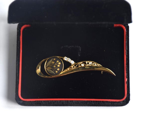 Amita Damascene Floral Brooch shown inside the open velvet presentation box