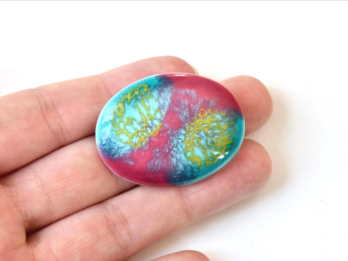 Kutani ceramic brooch shown in the palm of a hand for scale