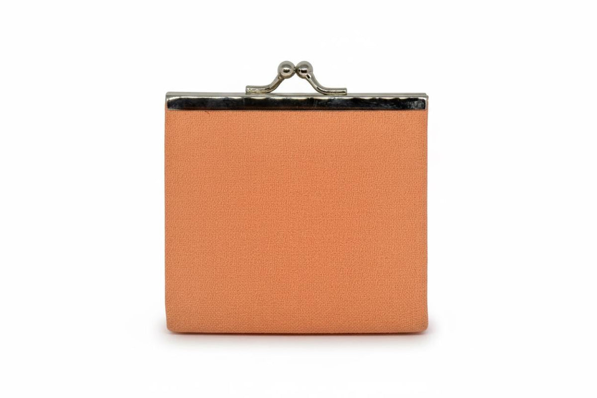 Peach Gamaguchi coin purse back view showing plain fabric surface