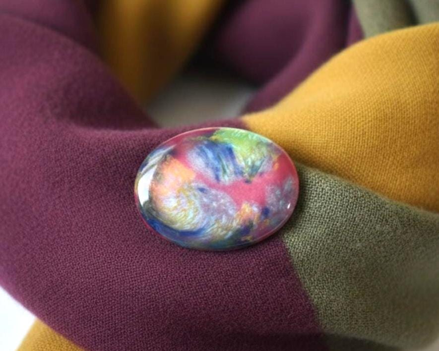 Kutani-Yaki Oval Ceramic Brooch Multicoloured Glaze pinned on a purple, olive, and mustard scarf