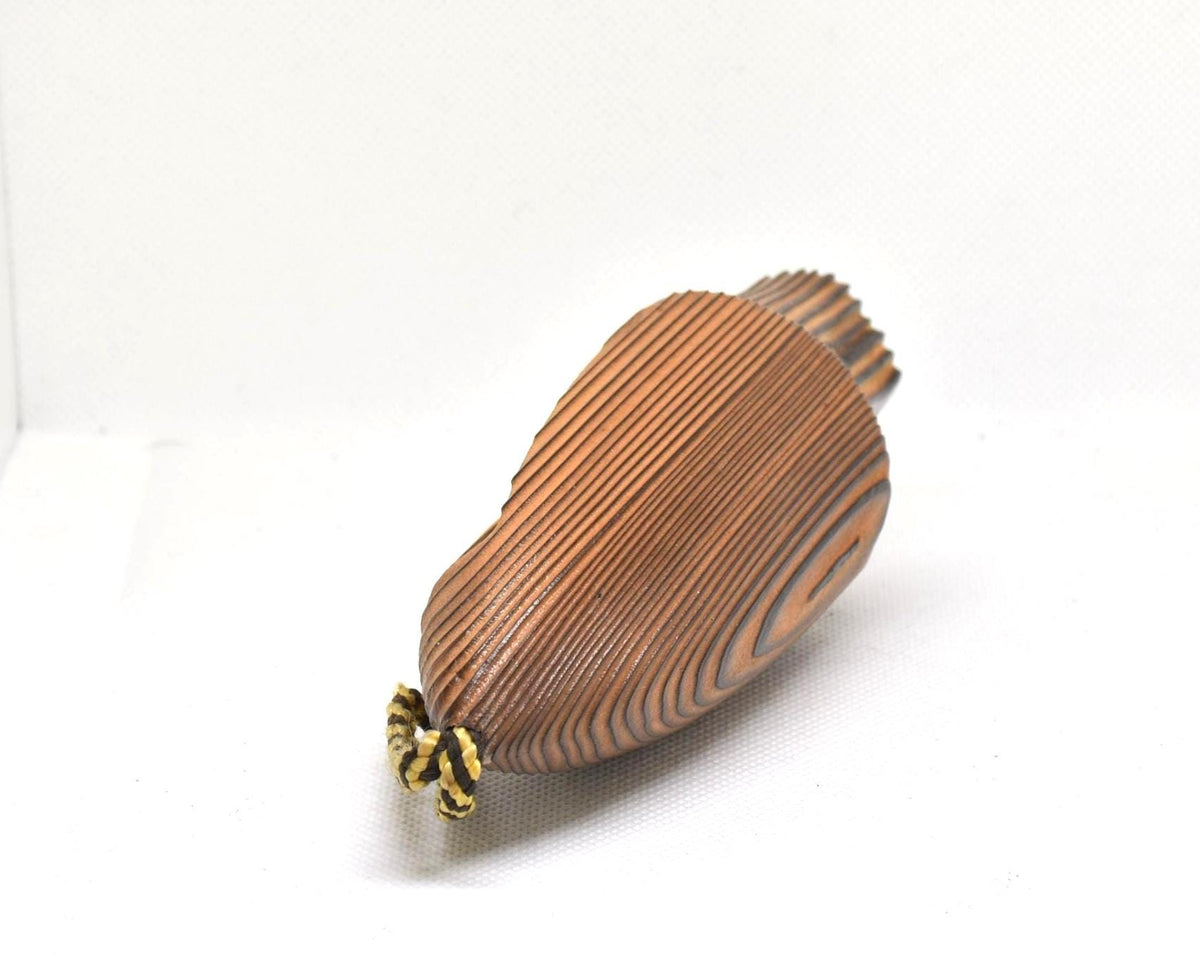 Cedar Wood Kokeshi Doll With Braided Cord, angled top view showing the attached braided cord loop