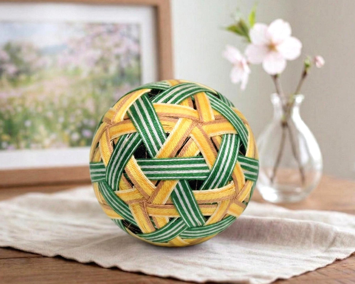 Temari Ball Embroidery traditional Japanese hand embroidered folk art object resting on a wooden table