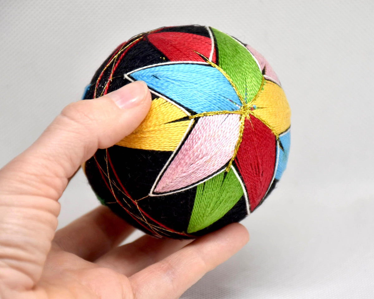 Japanese Temari ball size reference next to a hand