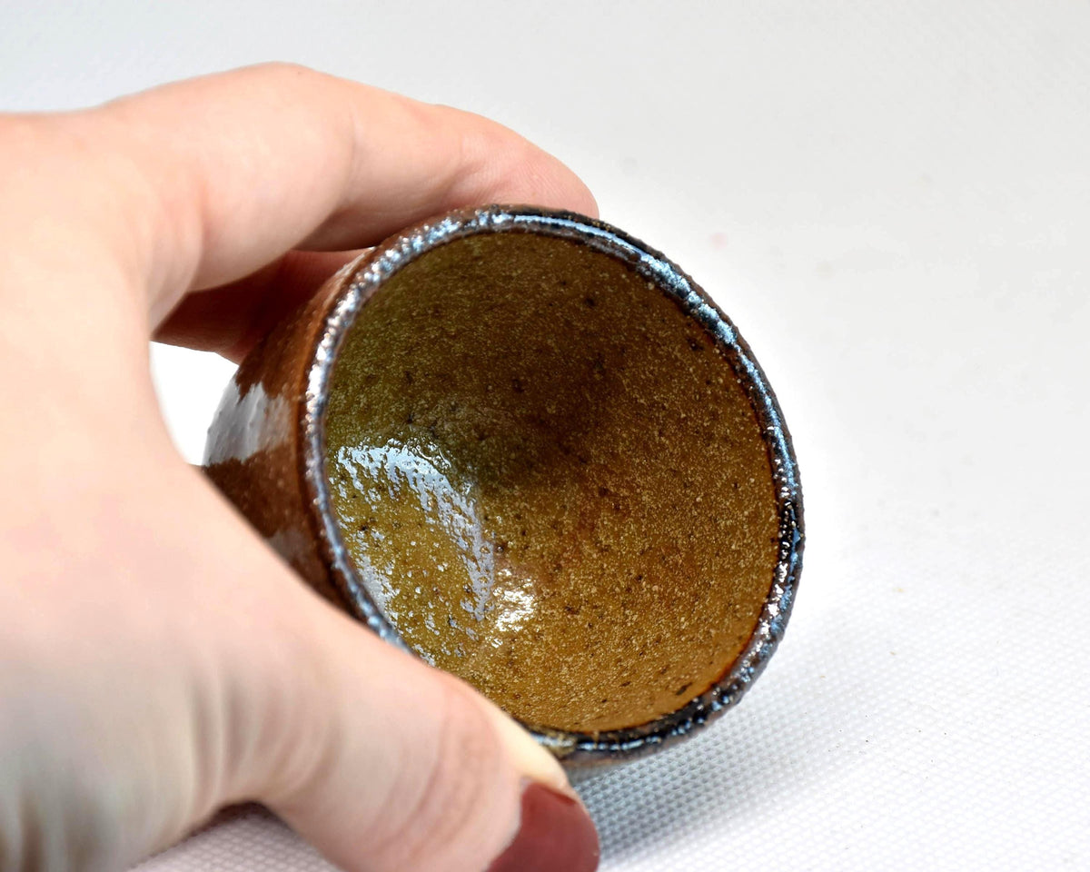 Karatsu ware guinomi sake cup, inside of the ceramic cup held in a hand