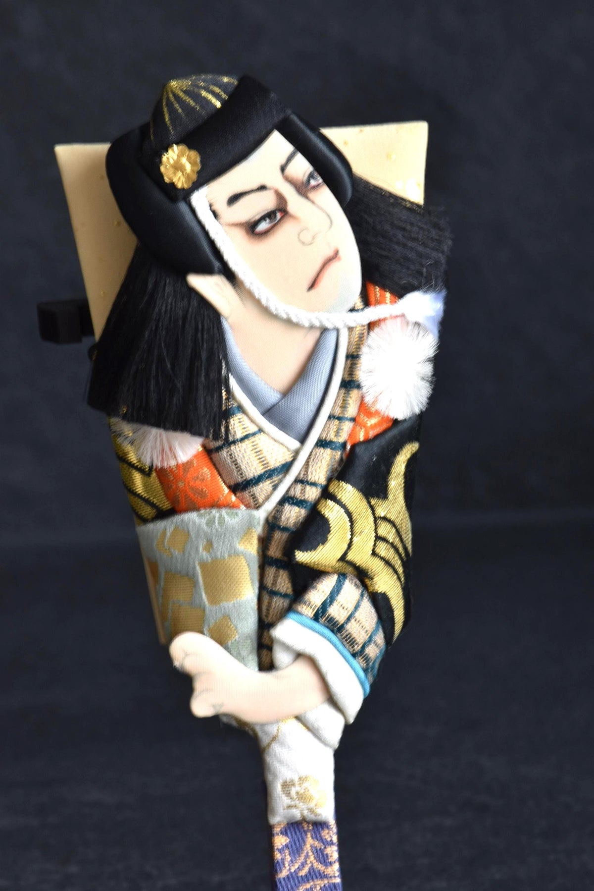 Japanese Hagoita Battledore With Kimono Doll close up portrait of the doll and traditional decorative kimono patterns