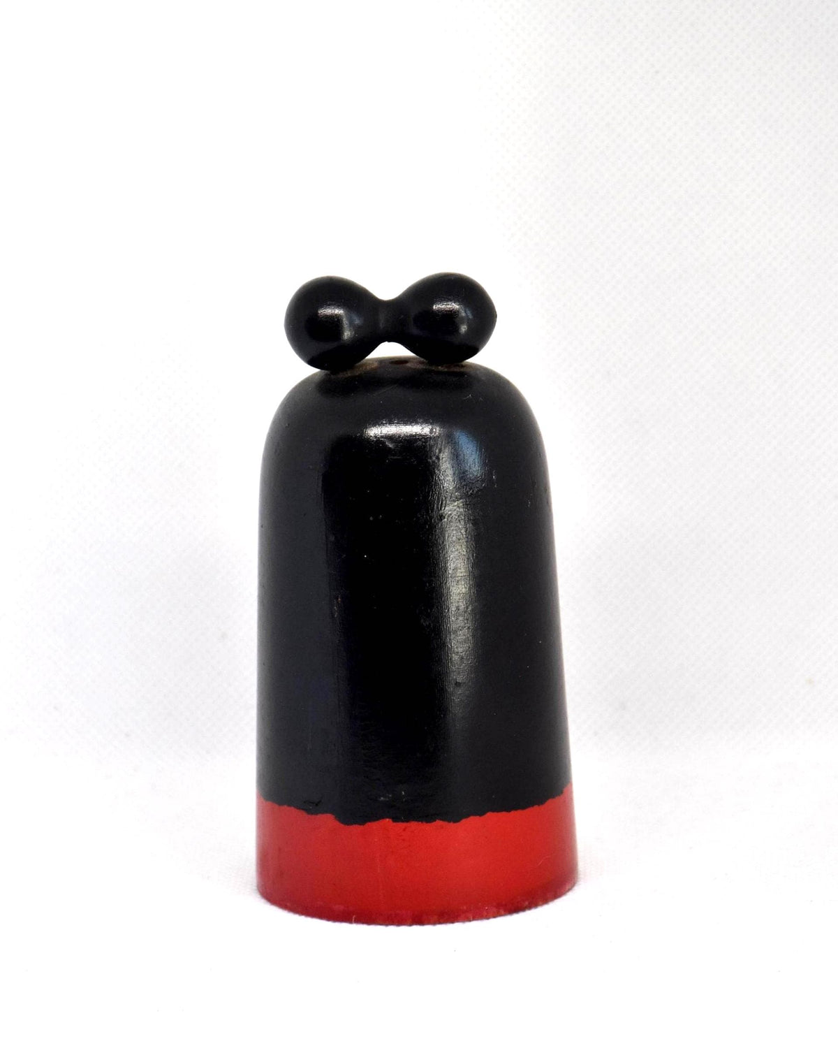 Japanese Kokeshi Doll With Black Ribbon showing the back view of the dark wooden body