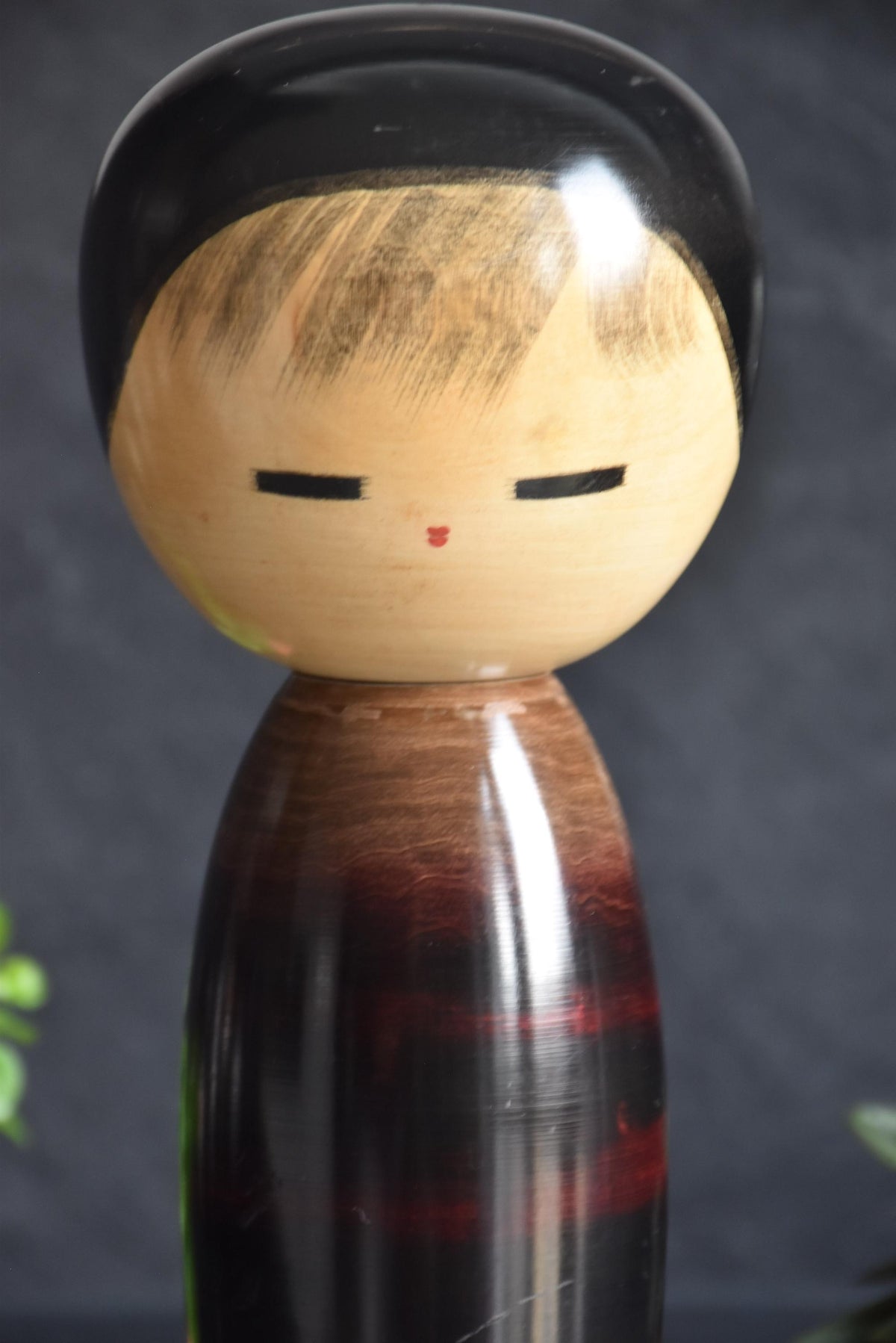 Masao Watanabe creative kokeshi doll close up of the peaceful closed eyes and facial features