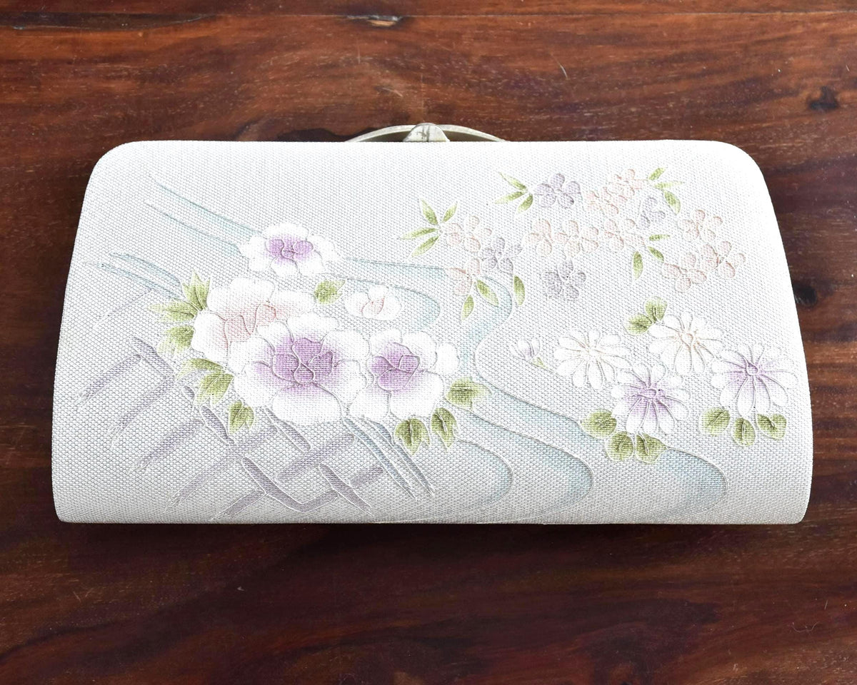 Japanese Floral Clutch With Raised Metallic Cord Detail shown from the front with tucked in chain