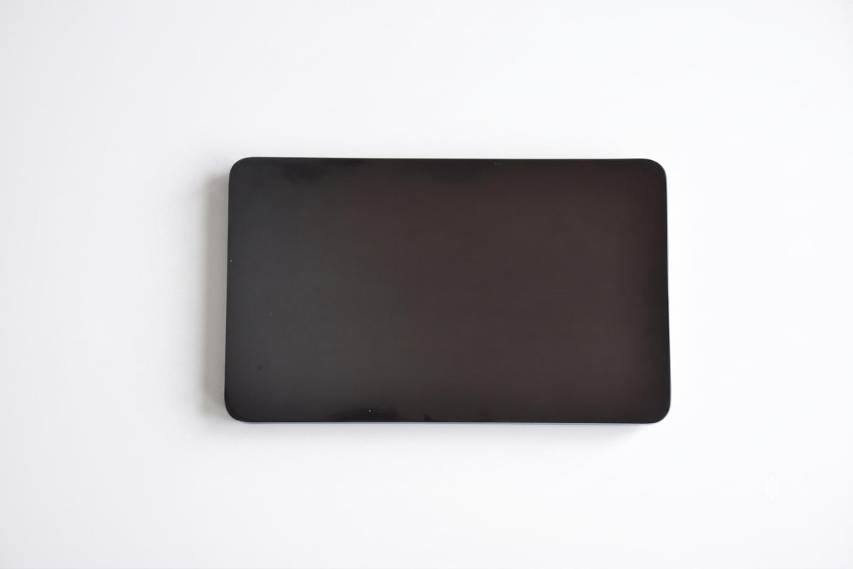 Back of the black lacquer serving tray with silver orchid inlay showing a plain dark finish