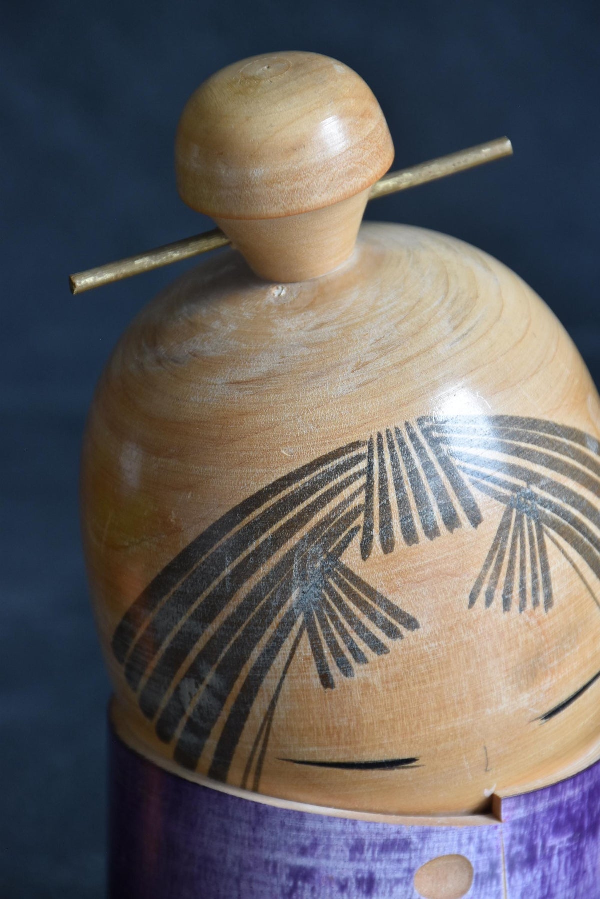 Sato Suigai kokeshi showing a detailed view of the finely incised bangs and eyes