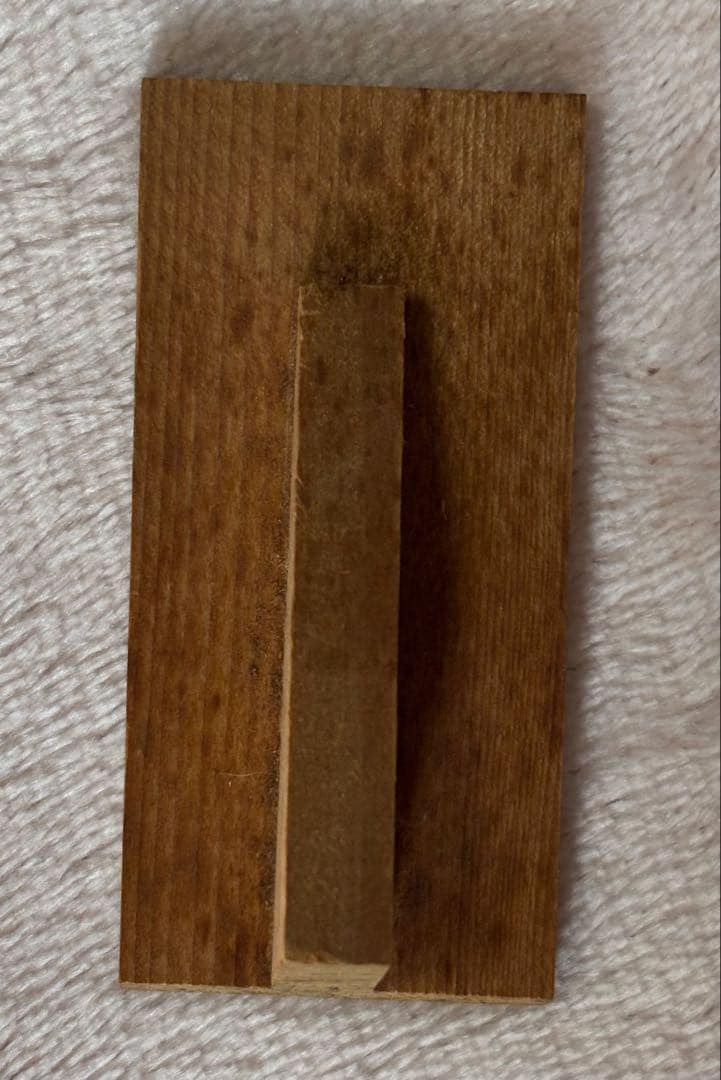 Toa Sekiguchi Sosaku Kokeshi Doll back view of the wooden artisan identification tag