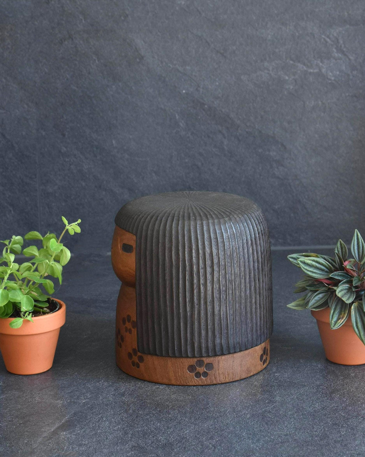 Sanpei Yamanaka kokeshi angled view showing dark carved hair and rounded form
