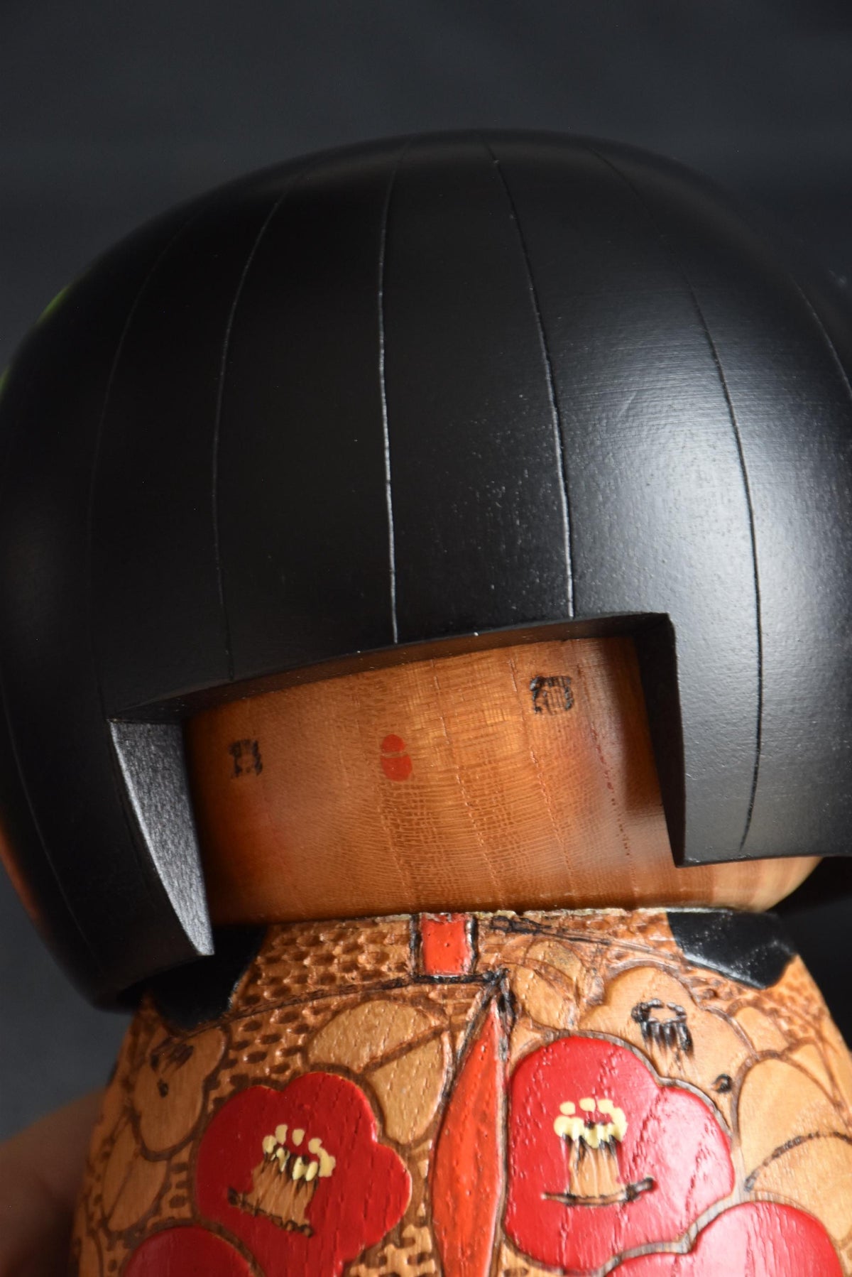 Kazuo Takamizawa kokeshi face close-up showing the minimalist features under the bob haircut