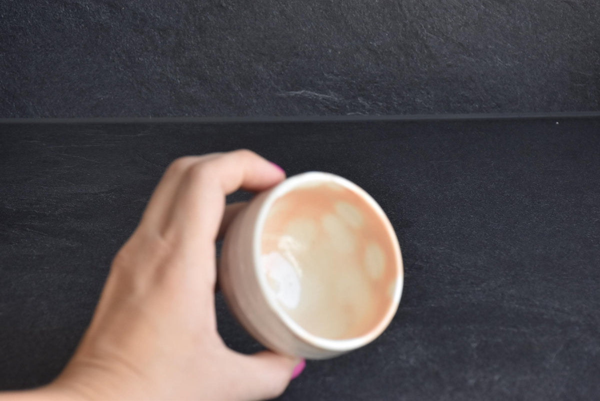 Set of 5 white kumidashi teacups interior view next to a hand