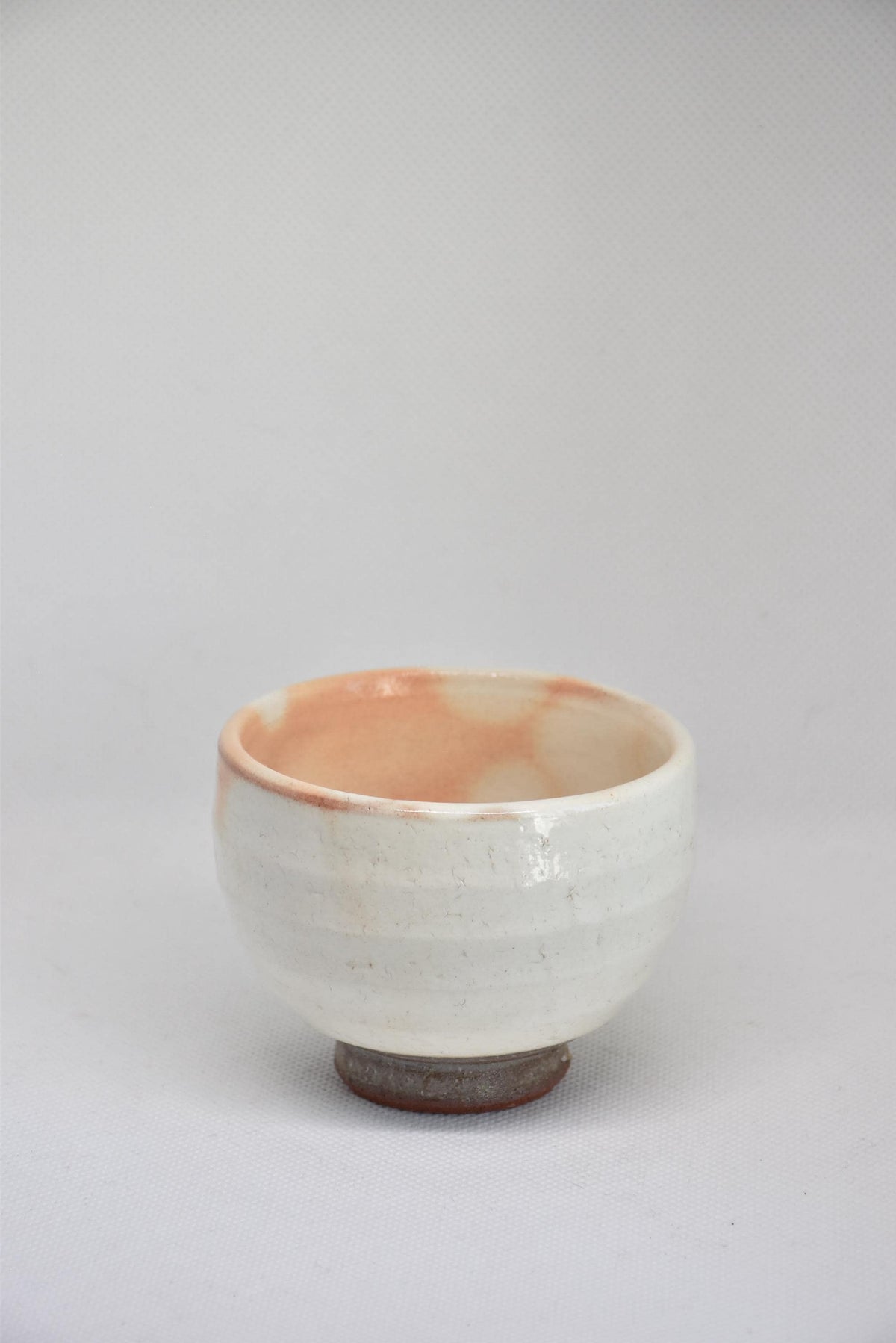 Set Of 5 White Kumidashi Teacups single cup showcasing the wide shallow profile and pink interior tone