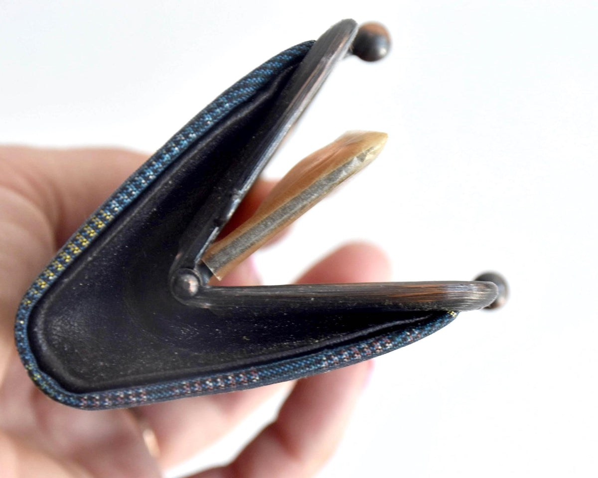 Blue Oshima Tsumugi Silk Gamaguchi Coin Purse held open from the side to display its profile and depth.