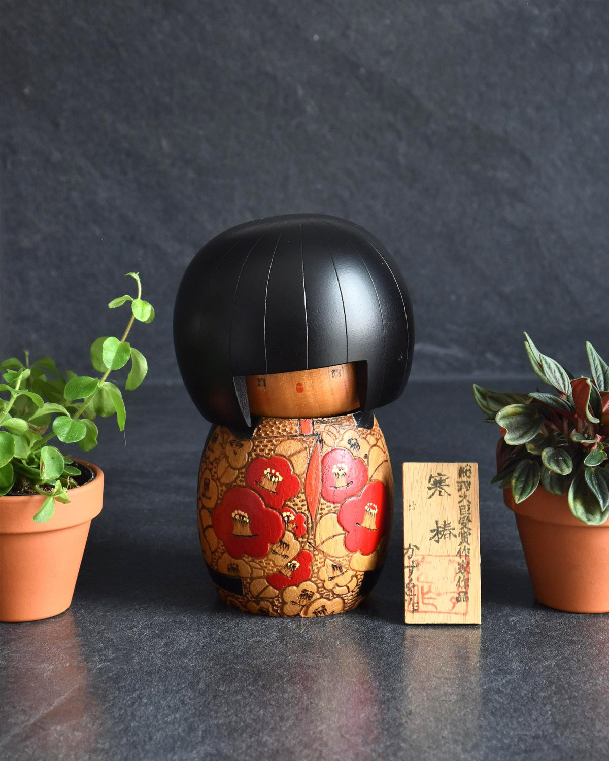 Kazuo Takamizawa Sosaku Kokeshi Tsubaki Camelia Doll with red and orange kimono patterns