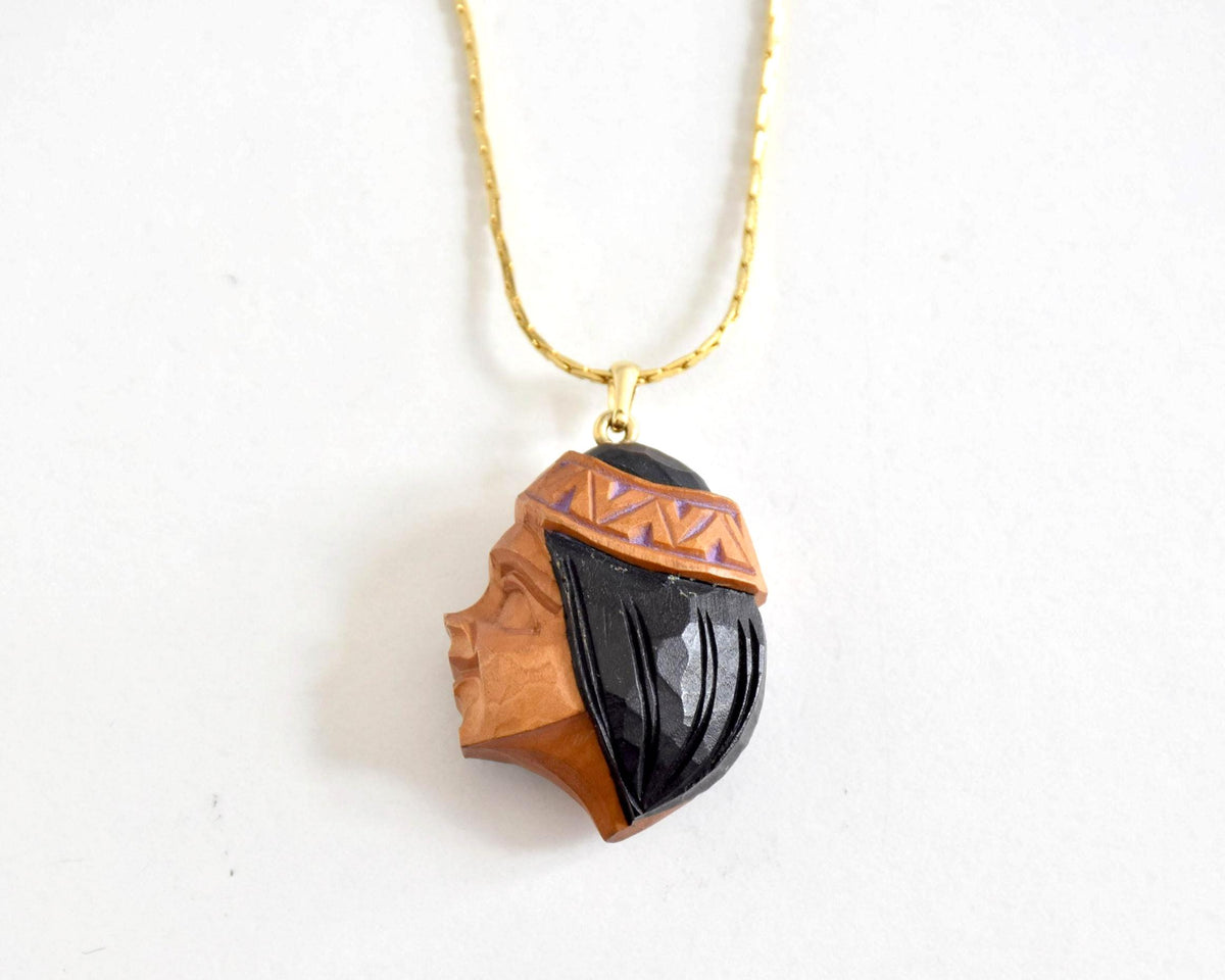 Ainu handcarved wood pendant necklace showing the woman profile portrait