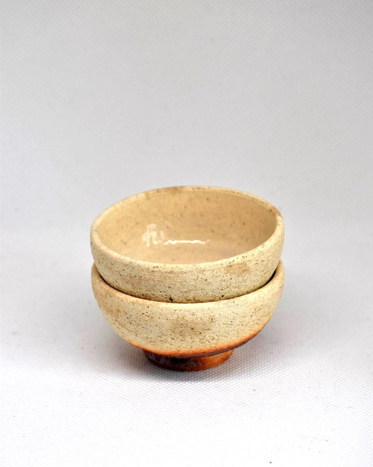 Ochre And Reddish-Brown Ceramic Sake Cup Pair stacked together