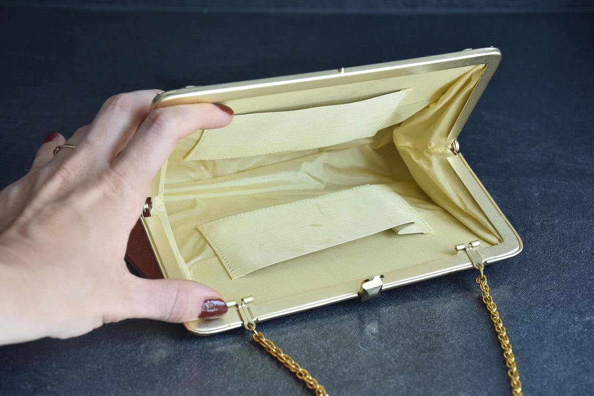Floral Woven Kimono Clutch With Ornate Metal Frame showing the inside fabric and pockets