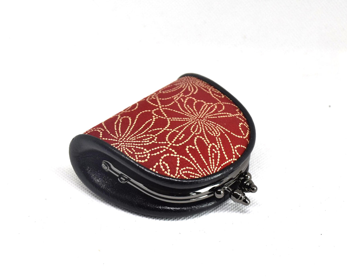 Inden deerskin coin purse angled view highlighting the curved metal frame and structure