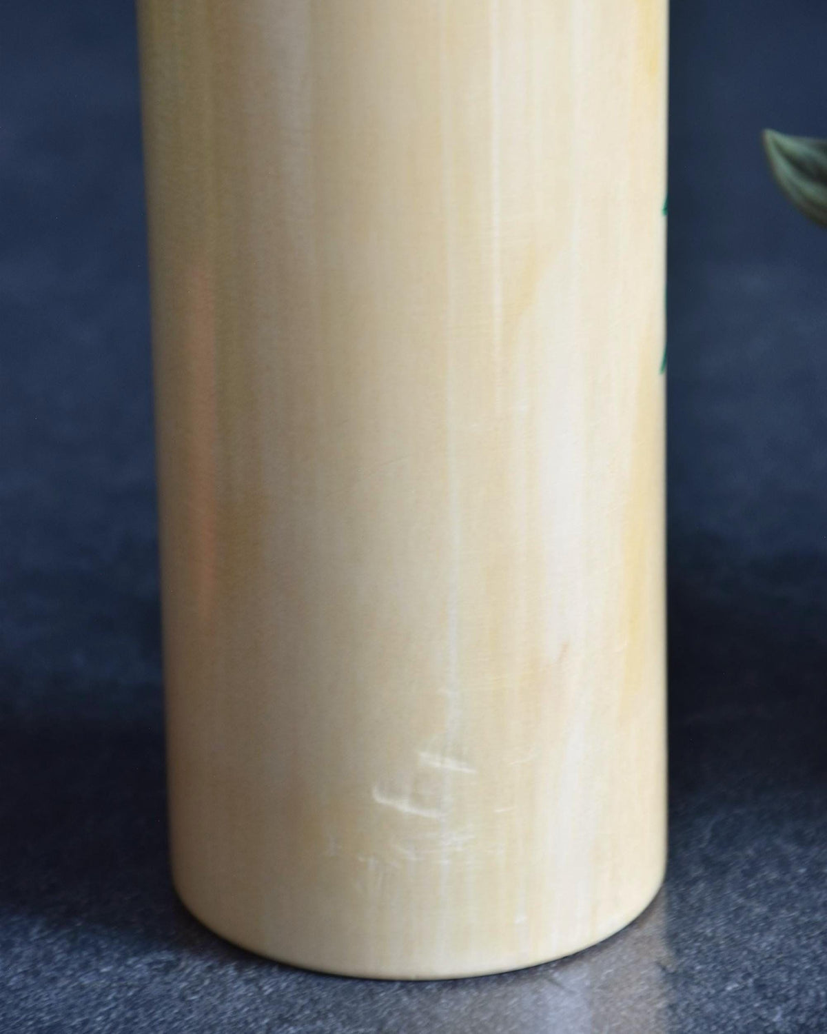 Pair of Japanese kokeshi dolls bamboo and floral motif lower body surface