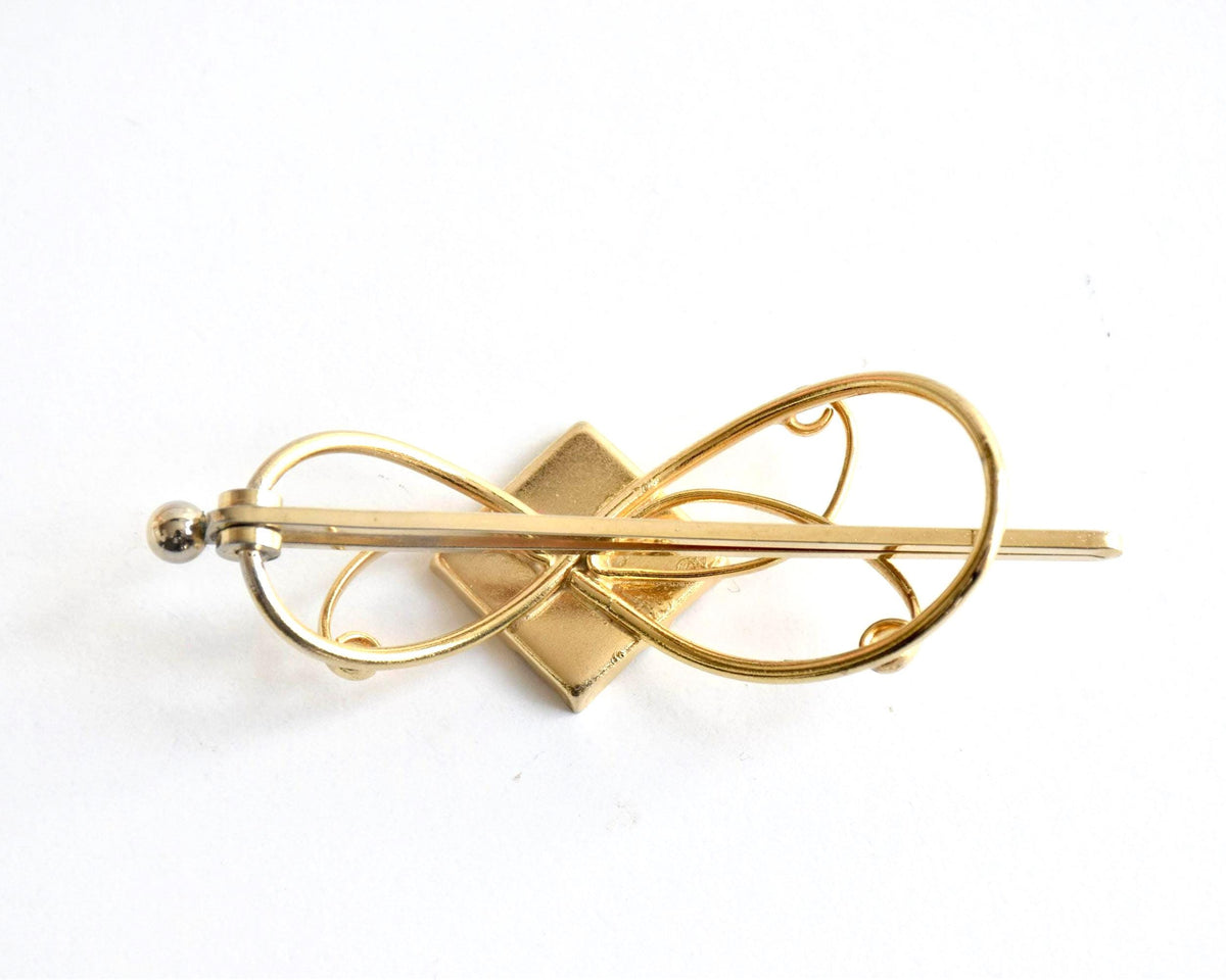 Floral Zogan Damascene Hair Ornament Gold And Black back view showing the metal clasp mechanism
