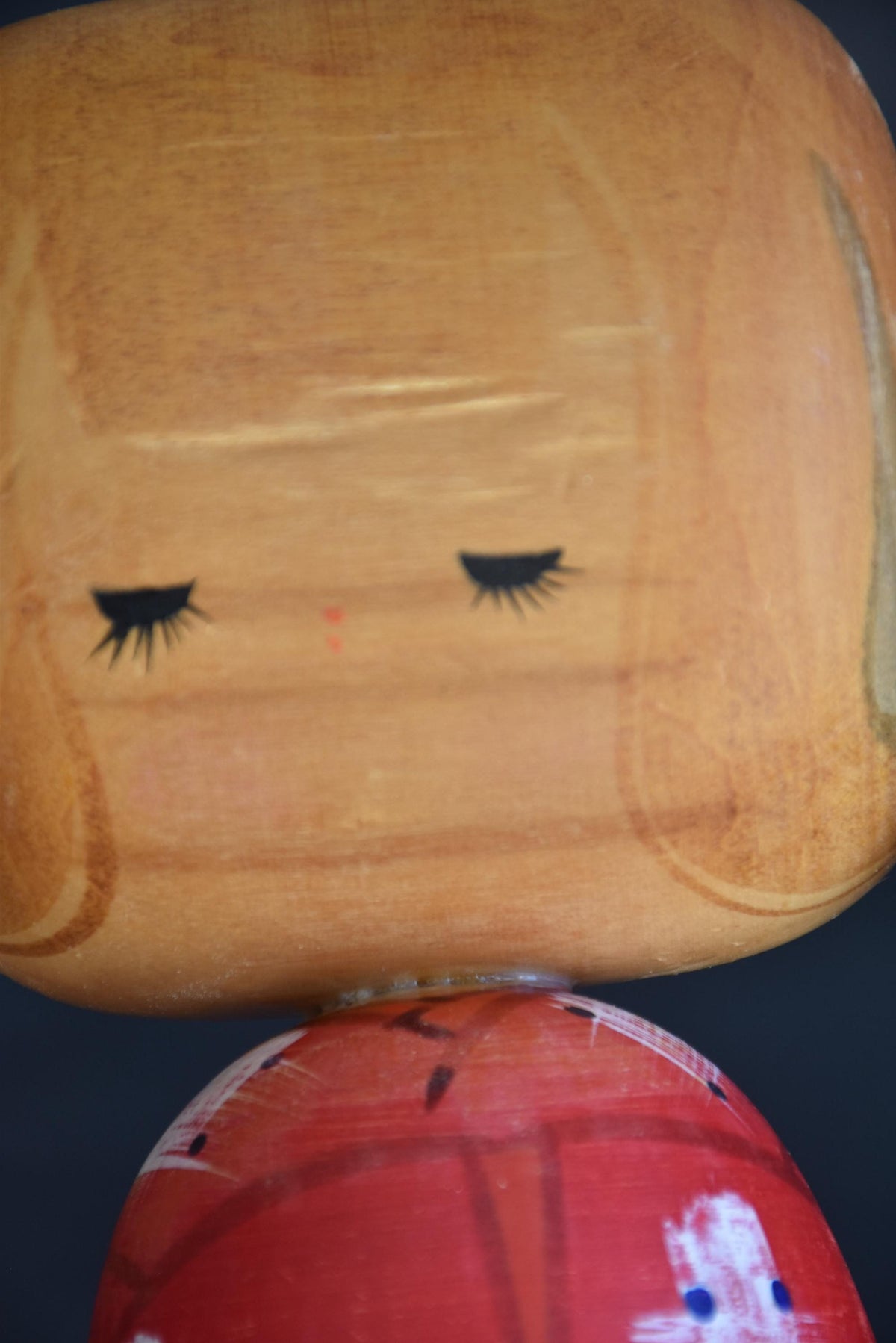 Hajime Miyashita Sosaku Kokeshi Red Geometric Ribbon showing face detail and neck area