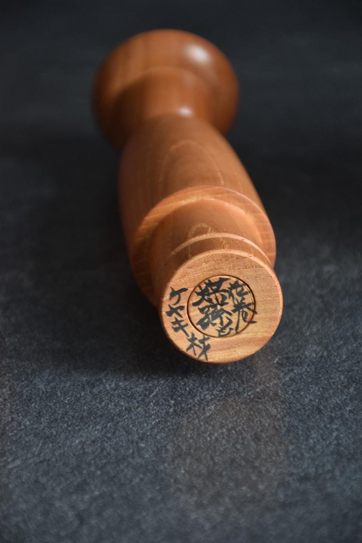 Kenji Miyazawa Dekunobo Hanamaki folk art kokeshi doll showing base with handwritten Japanese signature