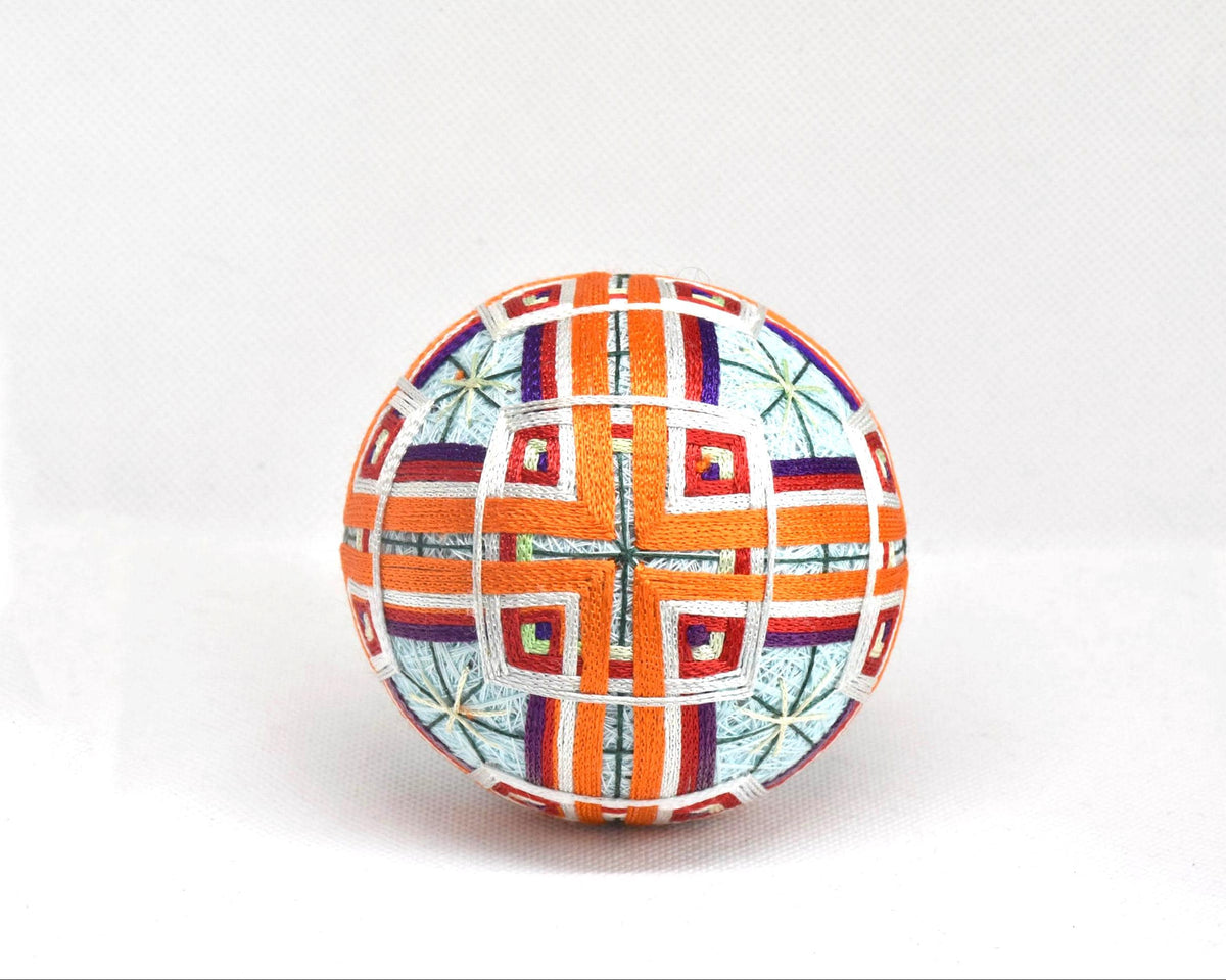 Traditional Japanese Temari ball featuring intricate hand embroidery and concentric square designs